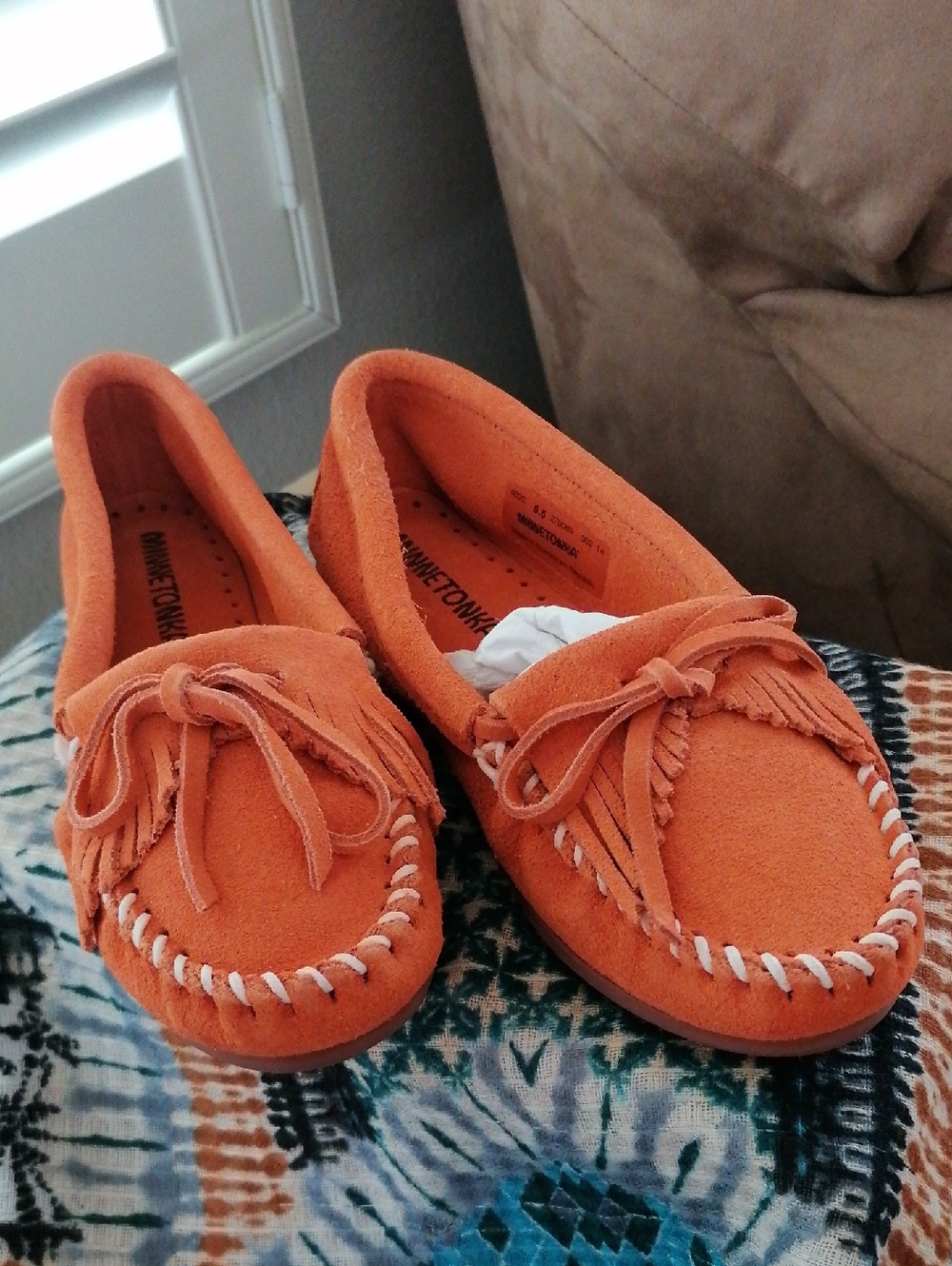 Minnetonka  Orange soft suede hard sole Moccasin.Never worn. Runs  big 5.5 = 6.5
